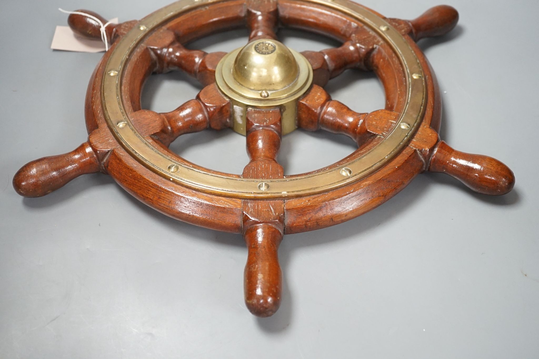 A teak and brass mounted Ship's wheel signed Lawrence Simpson 47cm